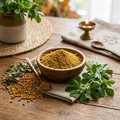 Pure Methi Fenugreek Powder in wooden bowl with whole methi seeds and green leaves